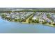 Picturesque aerial view of a lakeside community with well-maintained homes surrounded by lush greenery and trees at 9405 Bordet Ct, Orlando, FL 32827