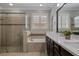 Bright bathroom featuring double sinks, bathtub, and a glass-enclosed shower at 9405 Bordet Ct, Orlando, FL 32827