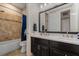 Well-lit bathroom featuring double sink vanity, framed mirror, and tiled shower-tub combo with updated fixtures at 9405 Bordet Ct, Orlando, FL 32827