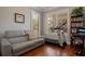 Bright room with hardwood floors, natural light streaming through the windows, and a gray leather couch at 9405 Bordet Ct, Orlando, FL 32827