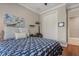 Cozy bedroom with hardwood floors, comfy bed, and neutral color scheme at 9405 Bordet Ct, Orlando, FL 32827