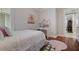 Bright bedroom with wood floors, a cozy bed, and a charming desk area at 9405 Bordet Ct, Orlando, FL 32827