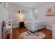 Cozy bedroom featuring hardwood floors, soft pink accents, and a playful Minnie Mouse rug at 9405 Bordet Ct, Orlando, FL 32827