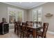 Dining room with large table, seating for eight, and views to the outdoor living space at 9405 Bordet Ct, Orlando, FL 32827