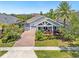 Beautiful single-Gathering home with a brick driveway, well-kept lawn, and colorful tropical landscaping at 9405 Bordet Ct, Orlando, FL 32827