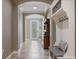 Bright foyer with tile flooring, arched doorways, and a decorative hall tree with bench at 9405 Bordet Ct, Orlando, FL 32827