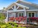 Stunning home featuring a welcoming front porch and meticulously landscaped front yard with vibrant red plants at 9405 Bordet Ct, Orlando, FL 32827