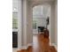 Hallway with hardwood floors leading to an office and a bathroom at 9405 Bordet Ct, Orlando, FL 32827
