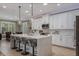 Elegant kitchen with a center island, stylish pendant lights, and modern appliances at 9405 Bordet Ct, Orlando, FL 32827