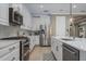 Beautiful kitchen showcasing stainless steel appliances, white cabinetry, and a spacious island at 9405 Bordet Ct, Orlando, FL 32827