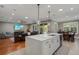 Open concept kitchen island with pendant lighting open to the living room at 9405 Bordet Ct, Orlando, FL 32827