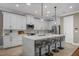 Stunning kitchen with an oversized island, stainless steel appliances, and white cabinetry at 9405 Bordet Ct, Orlando, FL 32827