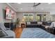 Cozy living room with a large leather sofa, ceiling fan, and recessed lighting at 9405 Bordet Ct, Orlando, FL 32827