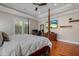 Spacious main bedroom featuring a four-poster bed, hardwood floors, and a tray ceiling at 9405 Bordet Ct, Orlando, FL 32827