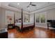 Spacious main bedroom with hardwood floors, tray ceiling, and plantation shutters at 9405 Bordet Ct, Orlando, FL 32827