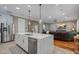 Open concept kitchen with island offering views of the living room at 9405 Bordet Ct, Orlando, FL 32827