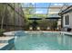 Inviting screened-in pool with tranquil waterfall feature and comfortable lounge seating at 9405 Bordet Ct, Orlando, FL 32827