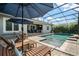 Inviting screened-in pool with relaxing spa and comfortable outdoor lounge area at 9405 Bordet Ct, Orlando, FL 32827