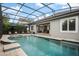 Spacious screened-in pool, perfect for relaxation, with an outdoor entertainment area at 9405 Bordet Ct, Orlando, FL 32827