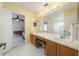 Ensuite bath featuring dual sinks and a large mirror at 115 Oak Grove Cir, Lake Mary, FL 32746