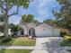 Charming single-story home with a well-manicured lawn, mature trees, and a three-car garage at 115 Oak Grove Cir, Lake Mary, FL 32746