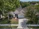 Charming single-story home with a well-maintained lawn, mature trees, and a two-car garage at 115 Oak Grove Cir, Lake Mary, FL 32746