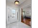 Bright foyer with tile flooring, decorative glass front door, and view into the living room at 115 Oak Grove Cir, Lake Mary, FL 32746