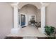 Inviting front porch with white columns, seating area, and a blue front door at 115 Oak Grove Cir, Lake Mary, FL 32746