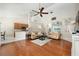 Bright living room with hardwood floors, ceiling fan, and adjacent kitchen area at 115 Oak Grove Cir, Lake Mary, FL 32746
