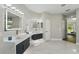 Bathroom featuring double vanities with vessel sinks and marble tile floors at 11508 Delwick Dr, Windermere, FL 34786