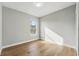 Clean, minimalist bedroom with hardwood floors, a window view and neutral paint to customize to your liking at 11508 Delwick Dr, Windermere, FL 34786