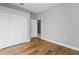 Empty bedroom featuring wood floor, neutral colored walls and a closet to customize to your liking at 11508 Delwick Dr, Windermere, FL 34786