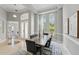 Bright dining room with contemporary decor, ample natural light, and adjacent doorway to the living area at 11508 Delwick Dr, Windermere, FL 34786