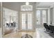 Bright foyer featuring a decorative compass floor inlay and views of the dining room and office at 11508 Delwick Dr, Windermere, FL 34786