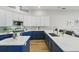 Bright, spacious kitchen with two-tone cabinetry, quartz countertops, tile backsplash, and stainless steel appliances at 11508 Delwick Dr, Windermere, FL 34786