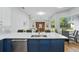 Open-concept kitchen features a large island with seating, quartz countertops, stainless steel appliances, and backyard views at 11508 Delwick Dr, Windermere, FL 34786
