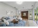 Inviting living room with hardwood floors, neutral colors, recessed lighting, and sliding glass doors to the backyard at 11508 Delwick Dr, Windermere, FL 34786