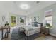 Bright main bedroom with wood floor, stylish rug, a sitting bench and backyard view at 11508 Delwick Dr, Windermere, FL 34786