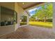 Covered patio with brick floor overlooking a manicured lawn at 11508 Delwick Dr, Windermere, FL 34786
