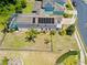 Aerial view of the home showing fenced-in backyard, screened in lanai and solar panels at 1204 Lexington Ave, Davenport, FL 33837