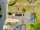 Aerial view of a home with solar panels, a screened-in pool, and an enclosed yard at 1204 Lexington Ave, Davenport, FL 33837