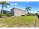 Large backyard with screened-in pool and lush tropical landscaping at 1204 Lexington Ave, Davenport, FL 33837