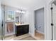 Bright bathroom featuring a dark vanity with granite countertop, neutral walls and tile flooring at 1204 Lexington Ave, Davenport, FL 33837