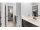 Well-lit bathroom features vanity with dark cabinets, white countertop, and a shower/tub with tile surround at 1204 Lexington Ave, Davenport, FL 33837