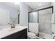 Bathroom with gray tile shower, glass door, and black hardware at 1204 Lexington Ave, Davenport, FL 33837