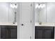 Bathroom featuring dual sinks with dark cabinetry, white countertops, and a door in the middle at 1204 Lexington Ave, Davenport, FL 33837