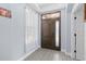 Warm foyer with wood-look tile flooring, wooden front door with sidelight window, and white trim at 1204 Lexington Ave, Davenport, FL 33837