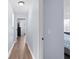 Hallway with neutral colored walls and hardwood flooring leading to the bedrooms at 1204 Lexington Ave, Davenport, FL 33837