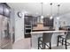 Modern kitchen with stainless steel appliances, granite countertops, and dark cabinetry, complete with a breakfast bar at 1204 Lexington Ave, Davenport, FL 33837