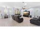 Spacious living room area featuring tile flooring, modern furniture, and a view of the backyard at 1204 Lexington Ave, Davenport, FL 33837